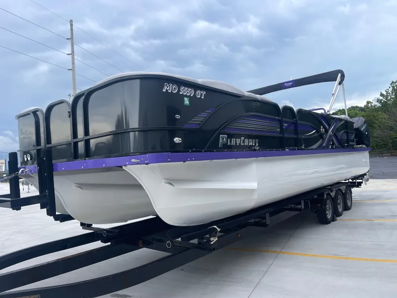 Slide: The Image of 2023 PlayCraft 3000 Infinity Extreme pontoon boat on trailer, parked outdoors. - 9