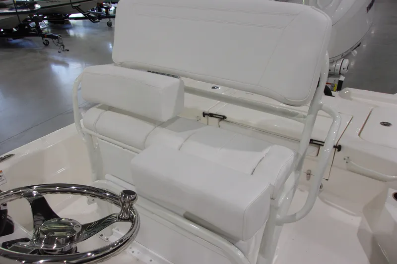 Slide: The Image of 2026 Skeeter 241 boat interior with white seating and steering wheel. - 14