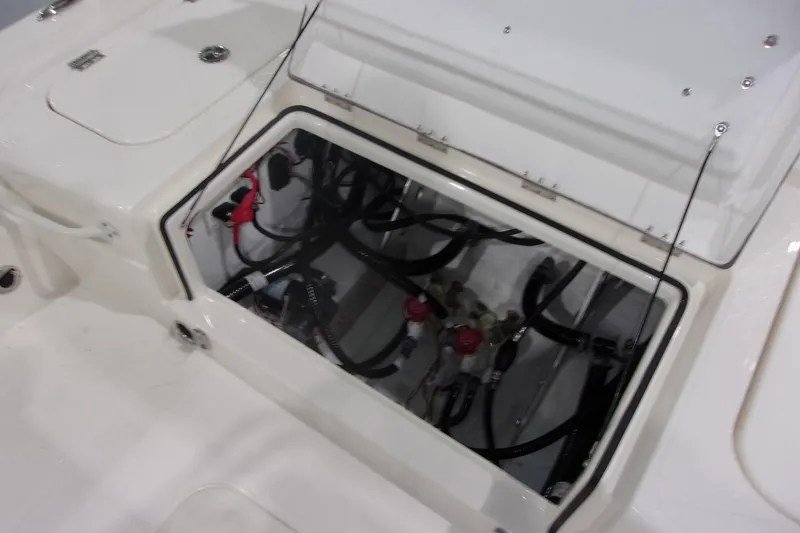 Slide: The Image of Open compartment of 2026 Skeeter 241 boat showing internal wiring and components. - 20