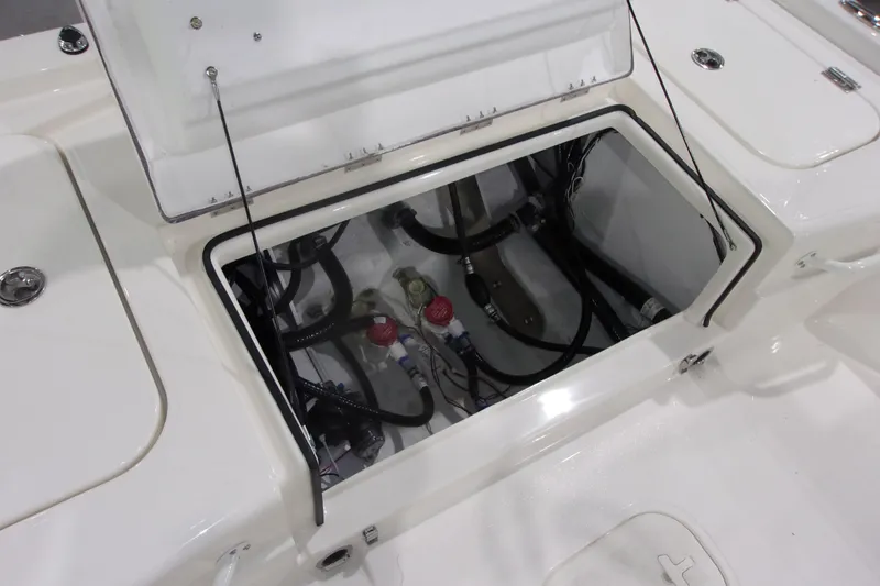 Slide: The Image of Open hatch of 2026 Skeeter 241 boat showing internal components and wiring. - 21
