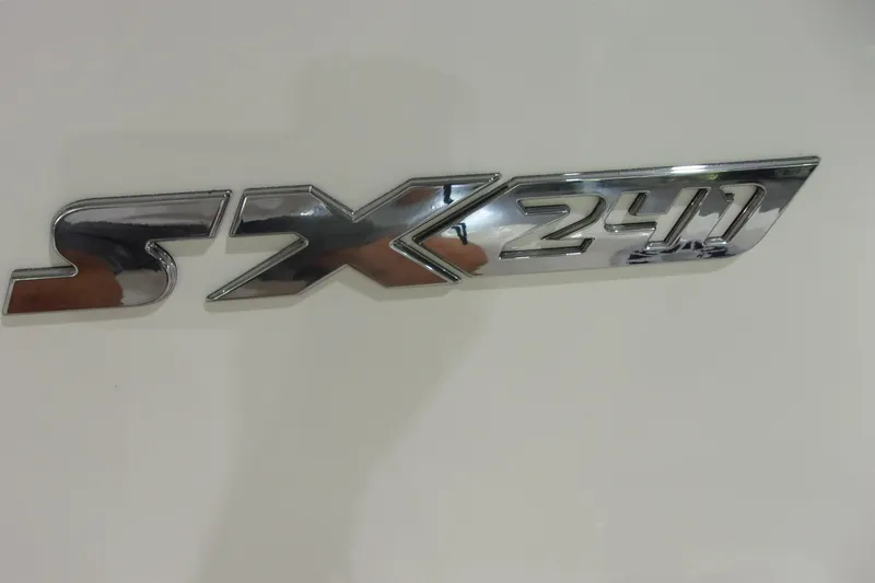 Slide: The Image of 2026 Skeeter SX 241 chrome emblem on white surface. - 22