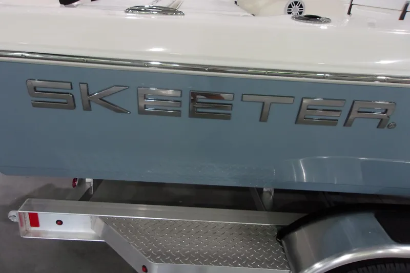 Slide: The Image of 2026 Skeeter 241 boat on trailer, showcasing sleek design and branding. - 23