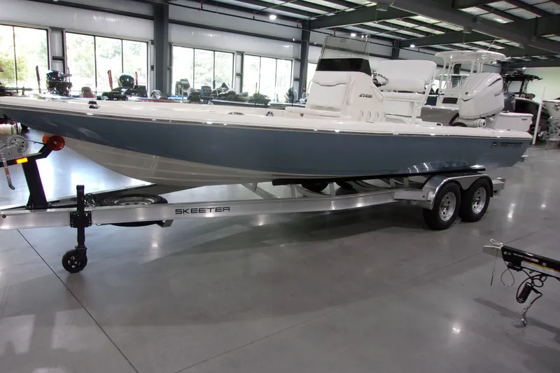 Slide: The Image of 2026 Skeeter 241 boat on trailer in showroom, side view. - 3