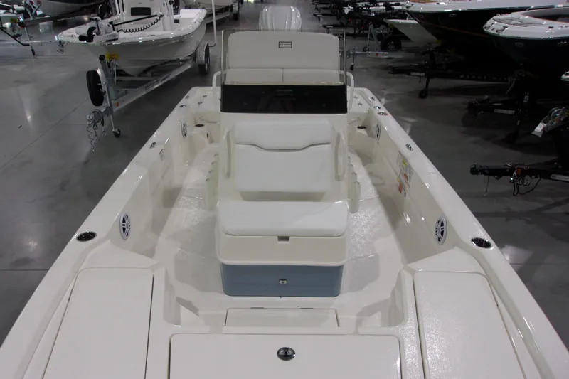 Slide: The Image of 2026 Skeeter 241 boat interior with seating and storage, displayed in a showroom. - 8