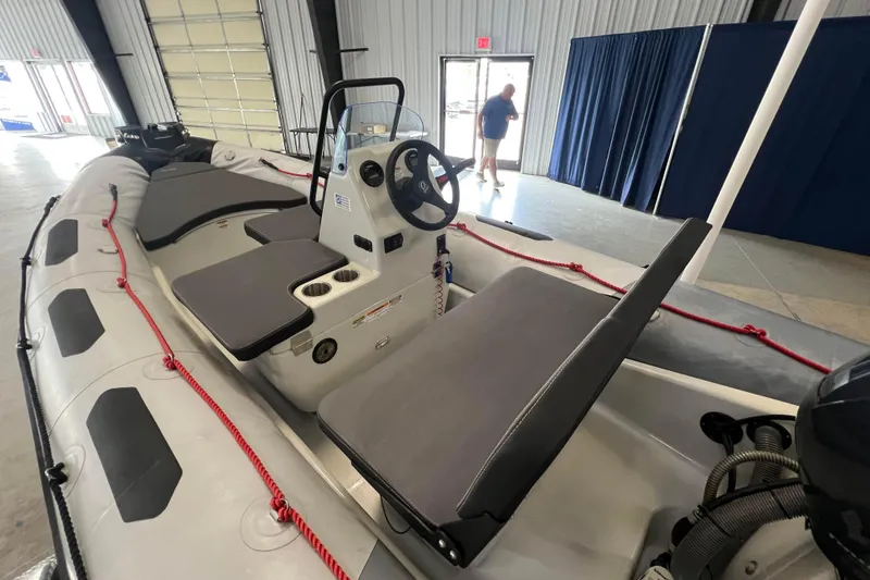 Slide: The Image of 2024 Zodiac Open 4.8 inflatable boat interior with seating and steering console. - 3