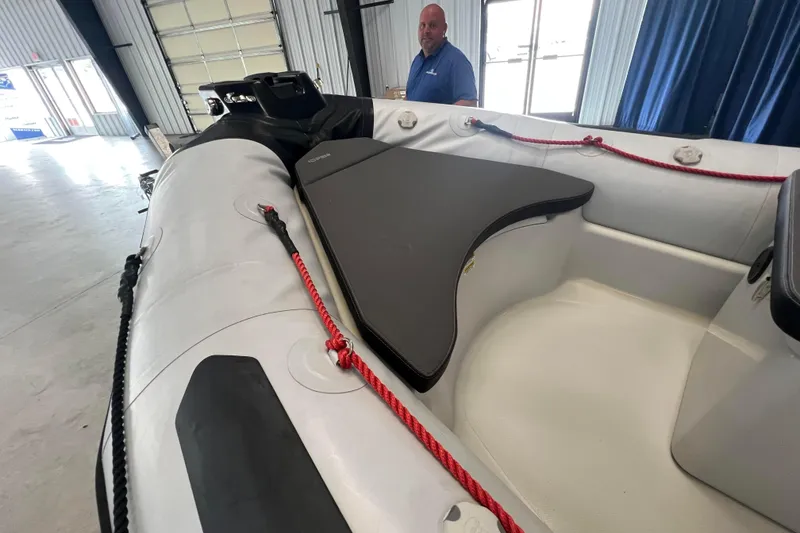 Slide: The Image of 2024 Zodiac Open 4.8 inflatable boat interior with red ropes and seating area. - 5