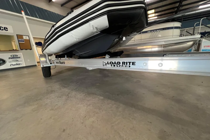 Slide: The Image of 2024 Zodiac Open 4.8 boat on Load Rite trailer in showroom. - 6