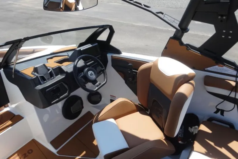 Slide: The Image of 2024 Axis T220 boat interior with tan and white seating, modern dashboard, and steering wheel. - 12
