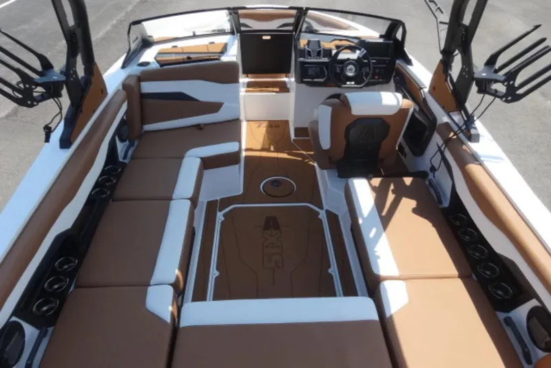 Slide: The Image of 2024 Axis T220 boat interior with brown and white seating, modern dashboard, and ample storage. - 8