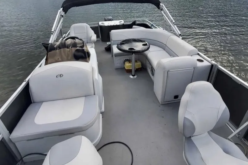Slide: The Image of 2016 Avalon Catalina LSZ Fish 20' pontoon boat interior with seating and table on water. - 3
