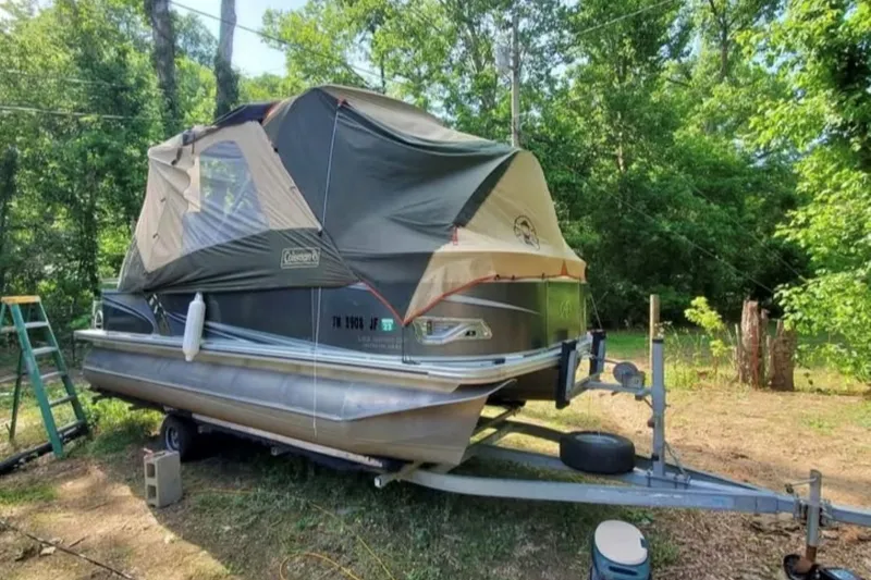 Slide: The Image of 2016 Avalon Catalina LSZ Fish boat with tent cover, parked on trailer in wooded area. - 4