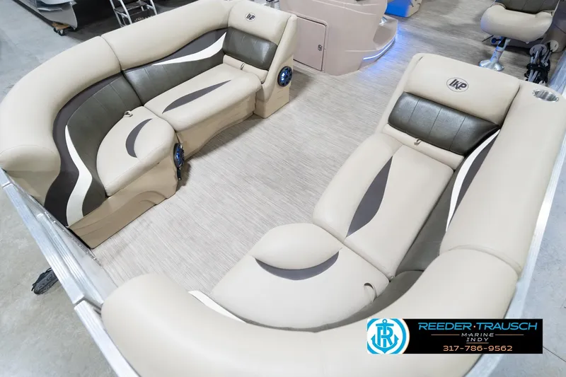 Slide: The Image of Luxurious seating in a 2020 Leisurecraft 2435 LX pontoon boat, featuring beige and black upholstery. - 11