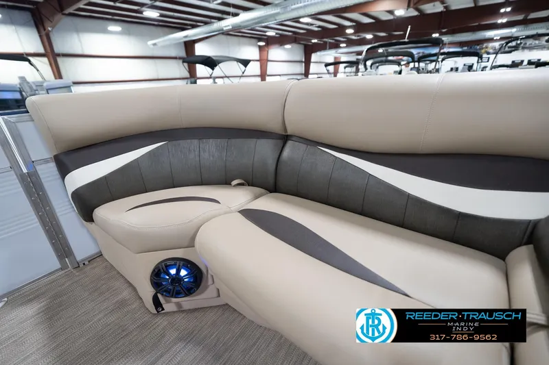 Slide: The Image of Luxurious seating in a 2020 Leisurecraft 2435 LX boat, featuring modern design and built-in speakers. - 23