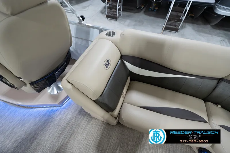 Slide: The Image of Luxurious seating on a 2020 Leisurecraft 2435 LX boat, featuring beige and gray upholstery. - 24