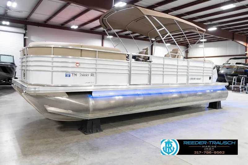 Slide: The Image of 2020 Leisurecraft 2435 LX pontoon boat in showroom with blue LED lights. - 3