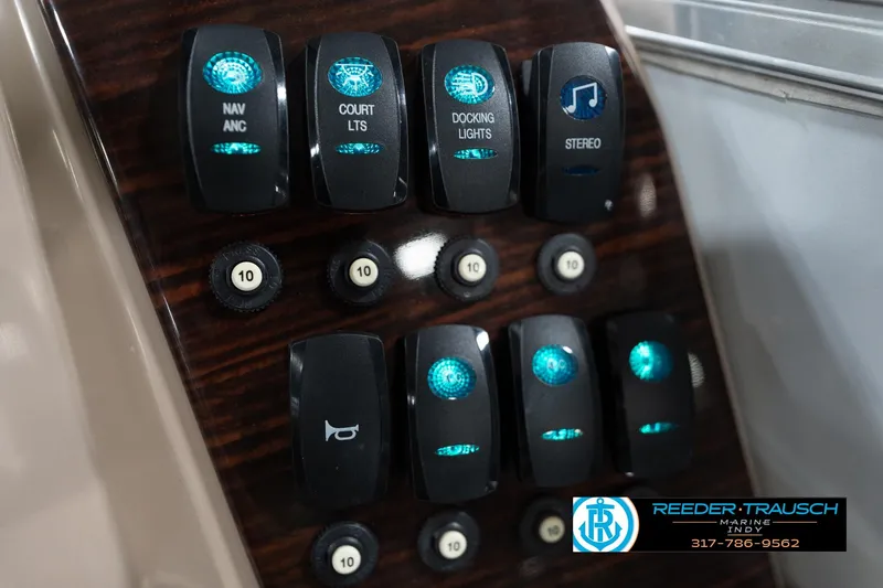Slide: The Image of Control panel of 2020 Leisurecraft 2435 LX boat with illuminated switches. - 35
