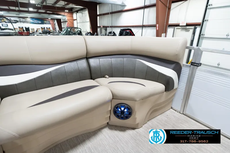 Slide: The Image of Luxurious seating in a 2020 Leisurecraft 2435 LX boat, featuring modern design and built-in speaker. - 39