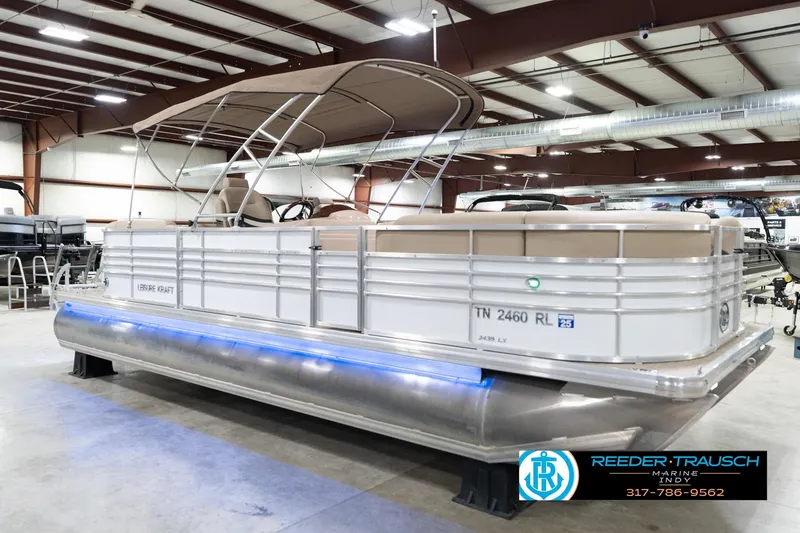 Slide: The Image of 2020 Leisurecraft 2435 LX pontoon boat in showroom with canopy and blue underglow lighting. - 5
