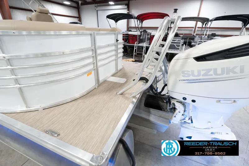 Slide: The Image of 2020 Leisurecraft 2435 LX pontoon boat with Suzuki outboard motor in showroom. - 52