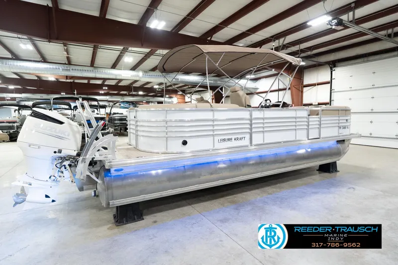 Slide: The Image of 2020 Leisurecraft 2435 LX pontoon boat in indoor showroom with Suzuki outboard motor. - 7