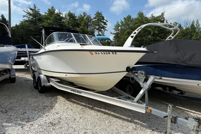 Slide: The Image of 2006 Mako 216 Dual Console boat on trailer, parked outdoors. - 1