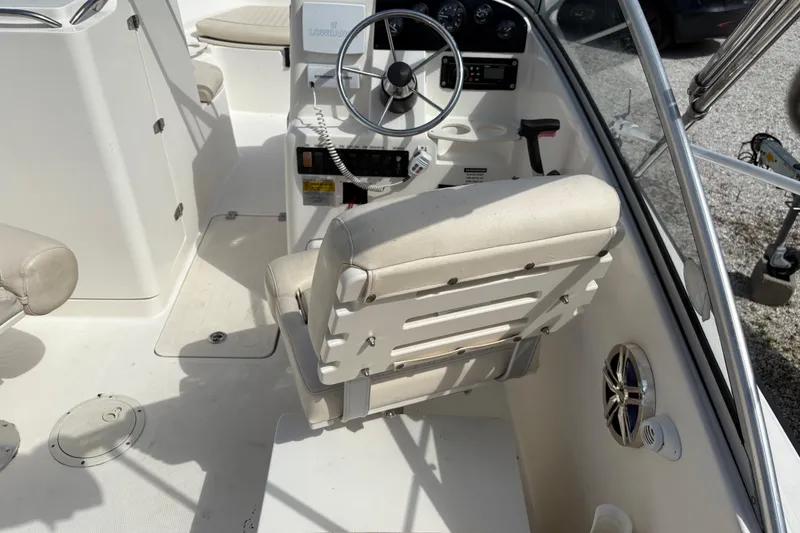 Slide: The Image of 2006 Mako 216 Dual Console boat interior with steering wheel and seating. - 11
