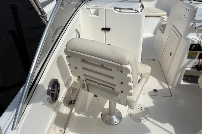 Slide: The Image of 2006 Mako 216 Dual Console boat interior with seating and speaker system. - 12