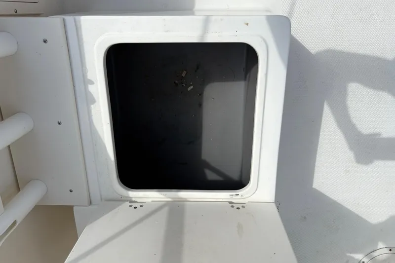 Slide: The Image of Open storage compartment on a 2006 Mako 216 Dual Console boat. - 13