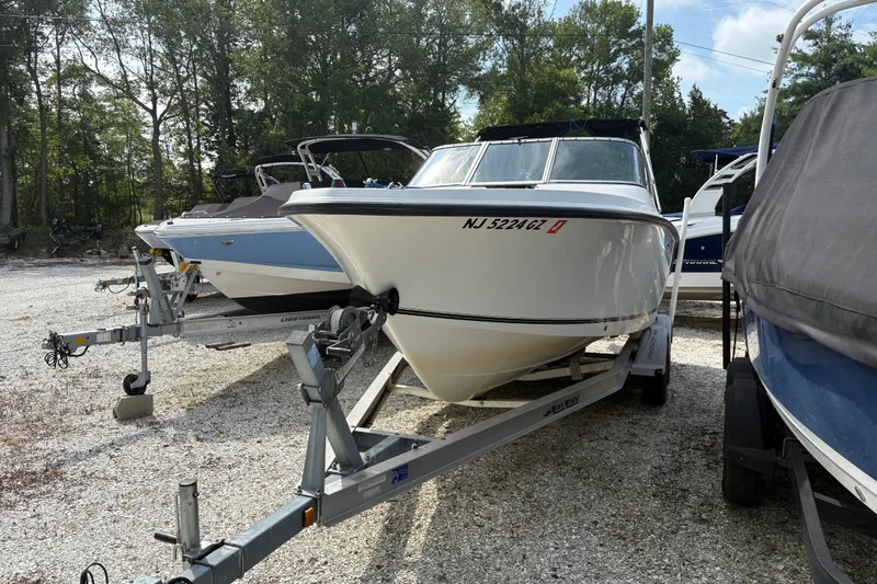Slide: The Image of 2006 Mako 216 Dual Console boat on trailer in outdoor storage area. - 2