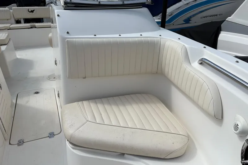 Slide: The Image of 2006 Mako 216 Dual Console boat interior with white cushioned seating. - 22