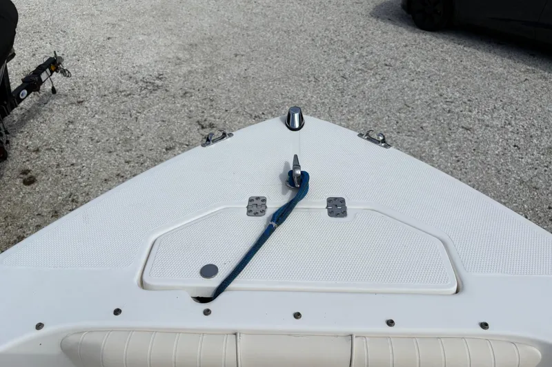 Slide: The Image of Bow of 2006 Mako 216 Dual Console boat with blue rope on deck. - 23