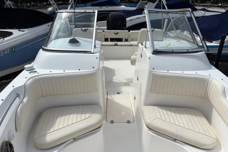 Slide: The Image of 2006 Mako 216 Dual Console boat interior with white seating and windshield. - 24