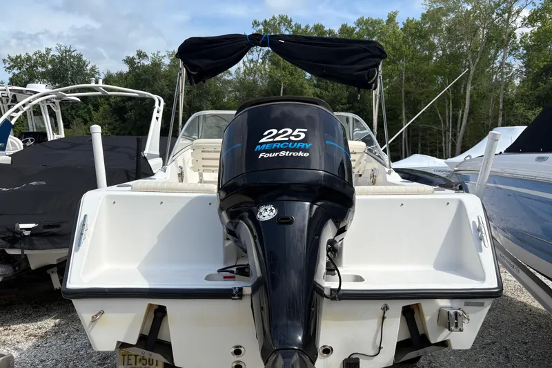 Slide: The Image of 2006 Mako 216 Dual Console boat with Mercury 225 FourStroke engine, docked outdoors. - 6