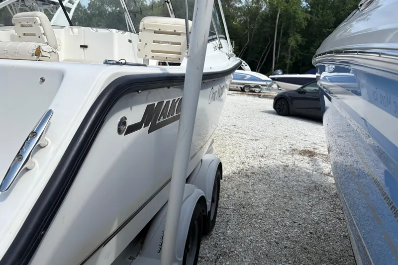Slide: The Image of 2006 Mako 216 Dual Console boat parked on gravel lot with other boats. - 7
