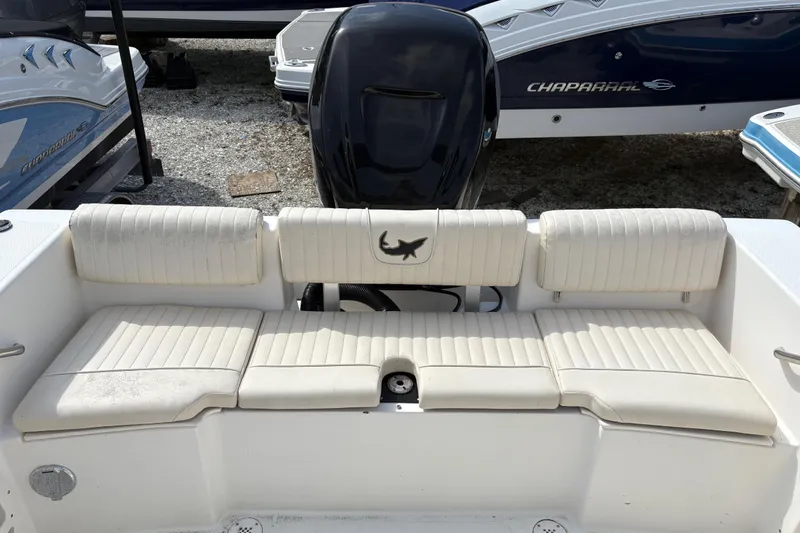 Slide: The Image of 2006 Mako 216 Dual Console boat with white cushioned seating and outboard motor. - 8