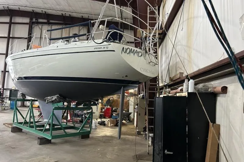 Slide: The Image of 1992 Pacific Seacraft Ericson 34-2 sailboat in indoor storage, elevated on a stand. - 13