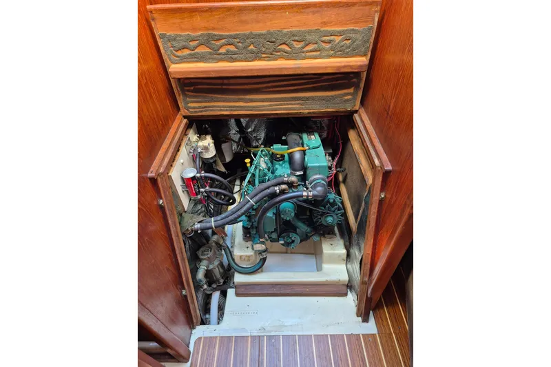 Slide: The Image of Engine compartment of a 1992 Pacific Seacraft Ericson 34 sailboat, showcasing detailed mechanics. - 14
