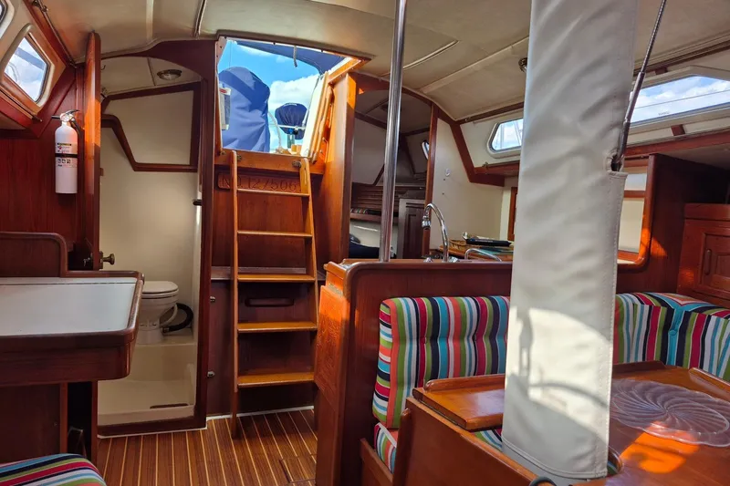 Slide: The Image of Interior of 1992 Pacific Seacraft Ericson 34 sailboat with colorful seating and wooden finishes. - 16