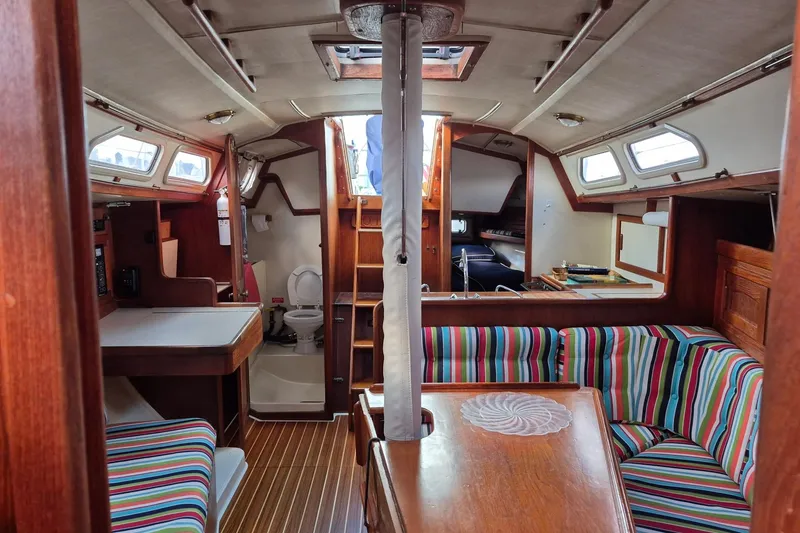 Slide: The Image of Interior of 1992 Pacific Seacraft Ericson 34 sailboat with striped seating and wooden finishes. - 17