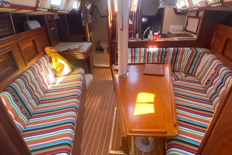 Slide: The Image of Interior of 1992 Pacific Seacraft Ericson 34-2 sailboat with colorful striped seating. - 18