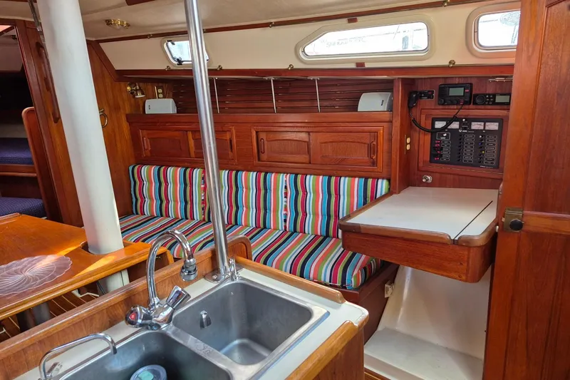Slide: The Image of Interior of 1992 Pacific Seacraft Ericson 34 sailboat with striped seating and wooden cabinetry. - 21