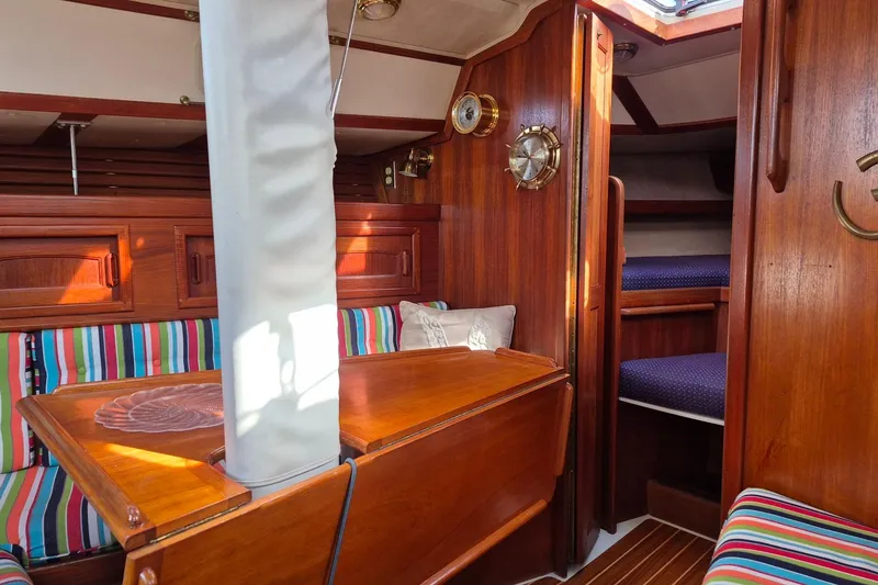 Slide: The Image of Interior of 1992 Pacific Seacraft Ericson 34 sailboat with wood finish and striped seating. - 23