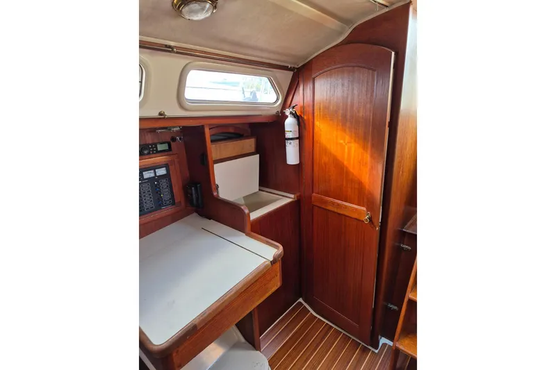 Slide: The Image of Interior of 1992 Pacific Seacraft Ericson 34 sailboat with wooden cabinetry and navigation station. - 25