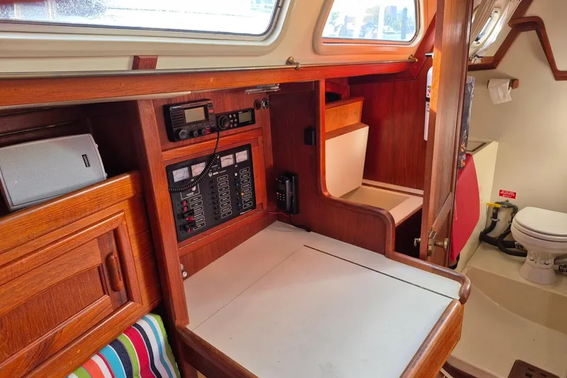 Slide: The Image of 1992 Pacific Seacraft Ericson 34 interior with navigation station and marine toilet. - 26