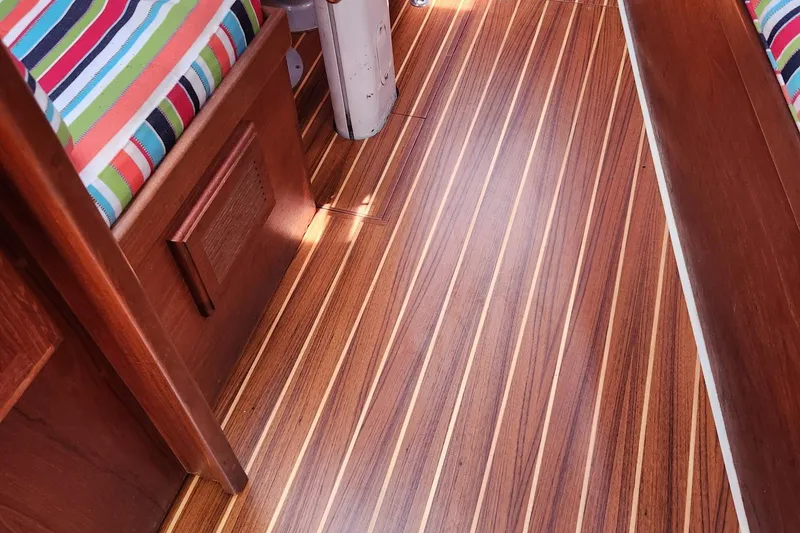 Slide: The Image of Interior of 1992 Pacific Seacraft Ericson 34-2 with striped cushions and wooden flooring. - 30