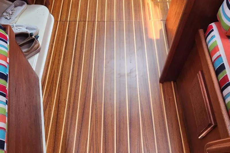 Slide: The Image of Teak and holly cabin sole on 1992 Pacific Seacraft Ericson 34-2 sailboat interior. - 31
