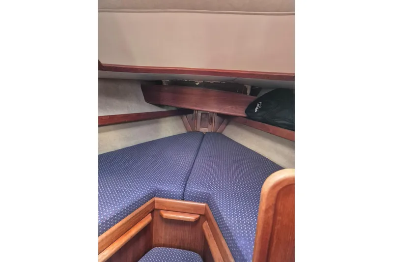 Slide: The Image of 1992 Pacific Seacraft Ericson 34 cabin interior with blue upholstery and wooden accents. - 32