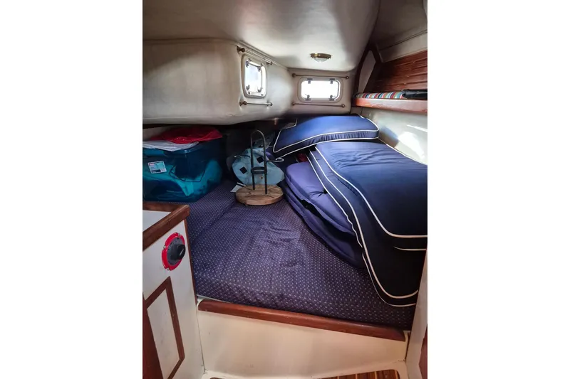 Slide: The Image of Cozy cabin interior of 1992 Pacific Seacraft Ericson 34 sailboat with blue bedding. - 34