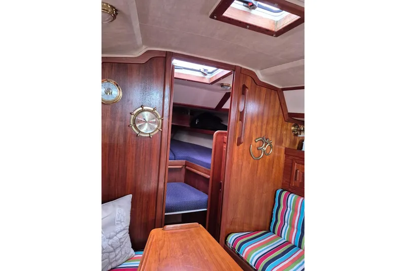 Slide: The Image of Interior of 1992 Pacific Seacraft Ericson 34 sailboat with wood paneling and striped seating. - 35