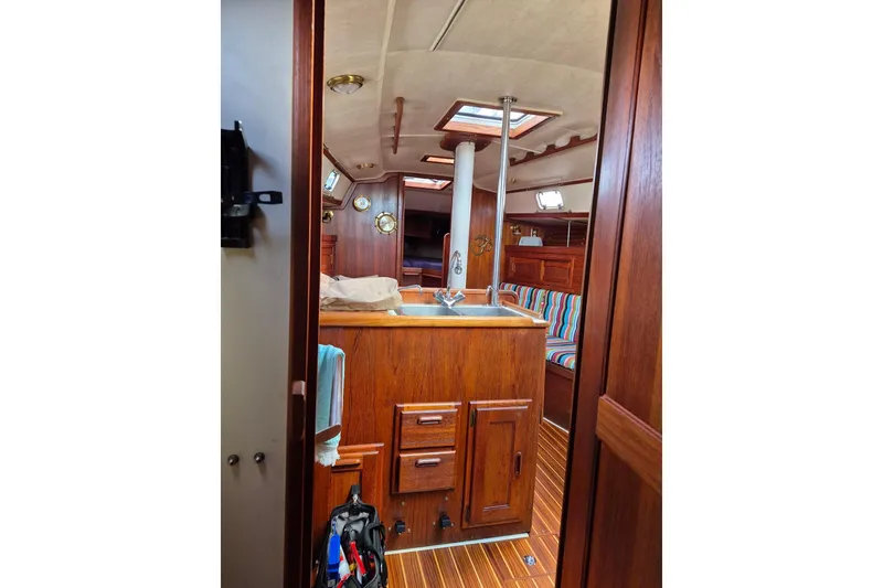 Slide: The Image of Interior of 1992 Pacific Seacraft Ericson 34 sailboat with wooden cabinetry and striped seating. - 36